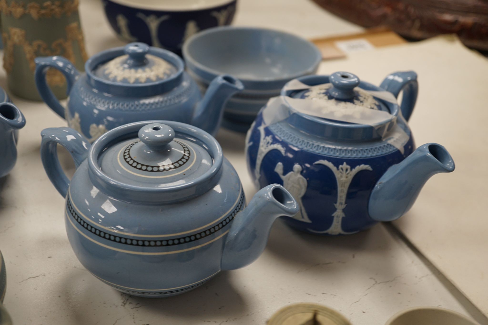 A collection of Dudson stoneware, including jugs, teapots, cream jugs etc, many decorated in low relief